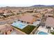 Wide aerial view of a spacious backyard with a pool, outdoor kitchen, and ample lawn space at 9096 Becket Ranch Ct, Las Vegas, NV 89113