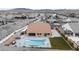 A beautiful backyard features a pool, outdoor kitchen, and plenty of room to entertain at 9096 Becket Ranch Ct, Las Vegas, NV 89113