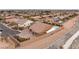 Wide shot of a tan two-story home with a tile roof, a three-car garage, and a sparkling backyard pool at 9096 Becket Ranch Ct, Las Vegas, NV 89113