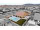 A sprawling backyard has a sparkling pool, outdoor kitchen, mature landscaping, and plenty of room to roam at 9096 Becket Ranch Ct, Las Vegas, NV 89113