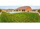 Expansive backyard features a large lawn area, a swimming pool, an outdoor kitchen and patio area at 9096 Becket Ranch Ct, Las Vegas, NV 89113