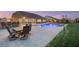Expansive backyard with a sparkling blue pool, dining and bar area, and lush green lawn at 9096 Becket Ranch Ct, Las Vegas, NV 89113