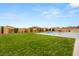 Backyard with a pool, seating area, an outdoor kitchen, a grassy yard, and block wall fencing at 9096 Becket Ranch Ct, Las Vegas, NV 89113
