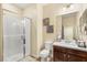 Bathroom features a tile shower and a dark wood vanity with a white sink at 9096 Becket Ranch Ct, Las Vegas, NV 89113