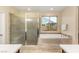 Bathroom featuring a tiled shower and soaking tub, providing a spa-like experience at 9096 Becket Ranch Ct, Las Vegas, NV 89113