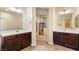 Spacious bathroom features separate sink vanities with dark wood cabinets and quartz countertops at 9096 Becket Ranch Ct, Las Vegas, NV 89113