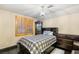 Bedroom features wood floors, a chandelier, privacy shutters, and dark wood furnishings at 9096 Becket Ranch Ct, Las Vegas, NV 89113