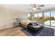 Bright bedroom with ceiling fan, hardwood floors, and access to outdoor patio at 9096 Becket Ranch Ct, Las Vegas, NV 89113