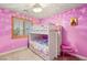Playful bedroom with pink walls, bunk beds, and a small pink piano at 9096 Becket Ranch Ct, Las Vegas, NV 89113