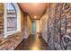 Inviting entryway with decorative iron door, stone accent wall, and tile flooring at 9096 Becket Ranch Ct, Las Vegas, NV 89113