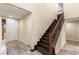 Home entryway features a dark wood staircase, decorative railings and wood-look tile flooring at 9096 Becket Ranch Ct, Las Vegas, NV 89113