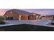 Beautiful home with three-car garage, brick driveway, stone accents, and desert landscaping at 9096 Becket Ranch Ct, Las Vegas, NV 89113