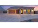 Elegant single-story home featuring stone accents, a tile roof, and a spacious three-car garage at 9096 Becket Ranch Ct, Las Vegas, NV 89113
