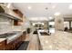 Gourmet kitchen featuring a large island, stone backsplash and stainless appliances at 9096 Becket Ranch Ct, Las Vegas, NV 89113