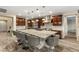Open kitchen with large island, stainless appliances and hard wood flooring at 9096 Becket Ranch Ct, Las Vegas, NV 89113