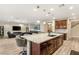 Open floor plan featuring the kitchen island with seating and granite counters at 9096 Becket Ranch Ct, Las Vegas, NV 89113