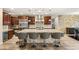 The kitchen features wood cabinets, stainless steel appliances, granite counters and bar stool seating at 9096 Becket Ranch Ct, Las Vegas, NV 89113
