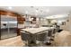 Spacious kitchen with granite counters, island, stainless appliances and modern lighting at 9096 Becket Ranch Ct, Las Vegas, NV 89113