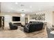 A living room displays a sleek, gray rug, stylish furniture, a large wall mirror and modern light fixture at 9096 Becket Ranch Ct, Las Vegas, NV 89113