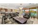 Spacious living room with tile floors, large television and access to the backyard patio at 9096 Becket Ranch Ct, Las Vegas, NV 89113