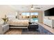 Bright main bedroom features a black leather couch, TV, and access to the backyard pool at 9096 Becket Ranch Ct, Las Vegas, NV 89113
