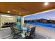Covered patio with ceiling fan, dining table, and view of the sparkling blue pool and home exterior at 9096 Becket Ranch Ct, Las Vegas, NV 89113