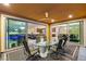 Covered patio featuring a dining table with seating and views of the backyard, living room, and kitchen at 9096 Becket Ranch Ct, Las Vegas, NV 89113