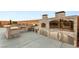 A stunning outdoor kitchen with bar, pizza oven, barbecue, and stainless steel storage at 9096 Becket Ranch Ct, Las Vegas, NV 89113