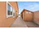 The side yard has access to a storage shed with brick pavers and a matching home at 9096 Becket Ranch Ct, Las Vegas, NV 89113