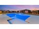 Inviting swimming pool with built-in waterfall feature and meticulously landscaped backyard at 9096 Becket Ranch Ct, Las Vegas, NV 89113