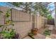 Landscaped backyard with a pergola, privacy wall, and well-maintained greenery, creating a serene outdoor space at 9926 Swimming Hole St, Las Vegas, NV 89183