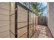 Backyard featuring a greenhouse, a privacy wall, and tiled flooring for a unique outdoor experience at 9926 Swimming Hole St, Las Vegas, NV 89183