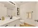 Well-lit bathroom with a modern vanity, framed mirror, and ample counter space and cabinets at 9926 Swimming Hole St, Las Vegas, NV 89183