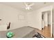 A comfortable bedroom with a ceiling fan, large window, and modern décor accents at 9926 Swimming Hole St, Las Vegas, NV 89183