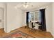 Cozy bedroom featuring a bright window, ample space, and wood flooring at 9926 Swimming Hole St, Las Vegas, NV 89183