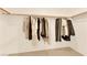 A closet featuring a rod with hanging clothes, providing storage space and organization at 9926 Swimming Hole St, Las Vegas, NV 89183