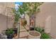 Enclosed courtyard with lush plants and greenery offers a tranquil outdoor living space at 9926 Swimming Hole St, Las Vegas, NV 89183