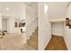 Hallway with stairs, leading to a kitchen and storage, featuring wood and tile flooring at 9926 Swimming Hole St, Las Vegas, NV 89183