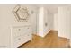 Hallway area featuring white cabinets and a stylish mirror, complemented by modern flooring at 9926 Swimming Hole St, Las Vegas, NV 89183