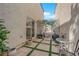 Serene patio featuring tiled flooring, green turf inlays, and garden views, ideal for relaxation and outdoor enjoyment at 9926 Swimming Hole St, Las Vegas, NV 89183