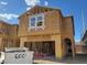 Unfinished two-story home with a garage, wood frame, and a large window at 10032 Indy Rey Ct, Las Vegas, NV 89148