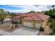 Aerial view of a single-story home with a tile roof, desert landscaping, and a spacious two-car garage at 10201 Los Padres Pl, Las Vegas, NV 89134