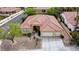 Bird's-eye view of a meticulously maintained home with desert landscaping, a two-car garage, and a striking tile roof at 10201 Los Padres Pl, Las Vegas, NV 89134