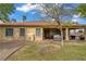 Spacious backyard featuring a covered patio, lush green grass, desert landscaping, and a cozy outdoor dining area at 10201 Los Padres Pl, Las Vegas, NV 89134