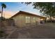 Back view of the property highlighting the covered patio and hardscaped backyard at 10201 Los Padres Pl, Las Vegas, NV 89134