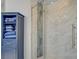 Walk in shower with marble tile, glass door, and blue cabinet for storage at 10201 Los Padres Pl, Las Vegas, NV 89134
