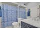 Bathroom featuring shower, marble vanity, and blue decor at 10201 Los Padres Pl, Las Vegas, NV 89134