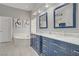 Bright bathroom with double vanity, marble countertops, soaking tub, and refined fixtures at 10201 Los Padres Pl, Las Vegas, NV 89134