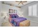 Cozy bedroom featuring ceiling fan, decorative lamps, and shuttered windows at 10201 Los Padres Pl, Las Vegas, NV 89134