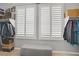 Walk in closet with lots of storage, plantation shutters and a grey bench at 10201 Los Padres Pl, Las Vegas, NV 89134